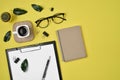 Office desk workspace with blank clip board, office supplies, pen, cactus, green leaf, coffee cup on a wooden stand and eye Royalty Free Stock Photo