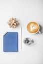 office desk workspace with notebook, pen, coffee, puzzle and paper clips in glass jar. Royalty Free Stock Photo