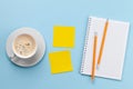 Office desk with yellow sticker, coffee and notepad Royalty Free Stock Photo