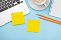 Office desk with yellow stickers, coffee and laptop Royalty Free Stock Photo