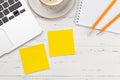 Office desk with yellow stickers, coffee and laptop Royalty Free Stock Photo