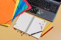 Office desktop with folders, laptop, opened notebook and pencils Royalty Free Stock Photo