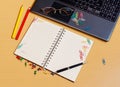 Office desktop with laptop, opened notebook and pencils Royalty Free Stock Photo