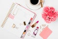 Pink Agenda With Make Up Products And Desk Accessories In A White Background