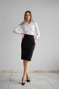 Office dress code - pretty girl in whithe shirt and tight black skirt. Royalty Free Stock Photo