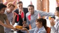 Office employees people in party hats congratulate happy female colleague