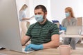 Office employees in respiratory masks