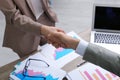 Office employees shaking hands over table with documents Royalty Free Stock Photo