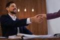 Office employees shaking hands over table with documents Royalty Free Stock Photo