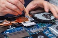 An office equipment repairman cleans bad thermal paste from the laptop& x27;s cooling system