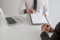 Office executives are interviewing job applicants in the meeting room