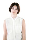 An office female isolated on a white background. A sad lady. A disappointed woman. A brunette girl wearing casual clothes. Royalty Free Stock Photo