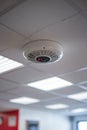 Office Fire Safety Ceiling - Mounted Smoke Detector, Textured Tile, Bright Natural Lighting Royalty Free Stock Photo