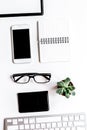 Office flat lay with keyboard, phone, notebook on white background top view mockup