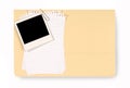 Manila office file folder with torn untidy notepaper and blank polaroid photo frame, copy space Royalty Free Stock Photo