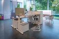 In office furniture exhibition there is a white height-adjustable desk combination