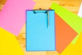 Office Hand Holding a Folder with a Blue Color Paper and Pen on the Colored Background of the Wooden Table. Copyspace. Place for T Royalty Free Stock Photo