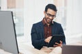 Office, happy Indian man at desk with tablet and computer, reading good news email or successful sales report online