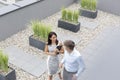 High angle view of businesswoman communicating with colleague at office terrace