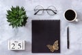 Office or home table desk. Wooden cubes calendar May 25. Black notepad, cup of coffee, succulent, glasses on marble background Royalty Free Stock Photo