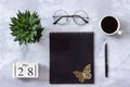 Office or home table desk. Wooden cubes calendar May 28. Black notepad, cup of coffee, succulent, glasses on marble background Royalty Free Stock Photo