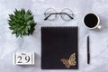 Office or home table desk. Wooden cubes calendar May 29. Black notepad, cup of coffee, succulent, glasses on marble background Royalty Free Stock Photo