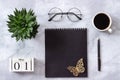 Office or home table desk. Wooden cubes calendar May 1st. Black notepad, cup of coffee, succulent, glasses on marble background Royalty Free Stock Photo