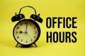 Office Hours text with alarm clock on yellow background Royalty Free Stock Photo