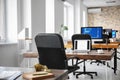 Office interior with computers and tables. Workplace design