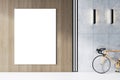 An office interior featuring a blank white poster frame on a wall, a modern bicycle on a gray concrete floor, and elegant wall Royalty Free Stock Photo