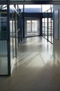 Office, interior and hallway with glass windows in passage or corridor of modern workplace. Empty corporate building Royalty Free Stock Photo