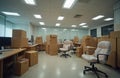 Office interior packed with boxes and covered chairs awaits relocation. Desks are cleared. The space is in transition, ready for Royalty Free Stock Photo