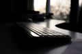 Office Keyboard with Sunset View Through Window Royalty Free Stock Photo
