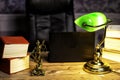 office of a lawyer with statue of Lady Justice, goddess Justitia, on the desk Royalty Free Stock Photo