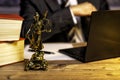 office of a lawyer with statue of Lady Justice, goddess Justitia, on the desk Royalty Free Stock Photo