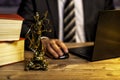 office of a lawyer with statue of Lady Justice, goddess Justitia, on the desk Royalty Free Stock Photo