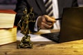 office of a lawyer with statue of Lady Justice, goddess Justitia, on the desk Royalty Free Stock Photo