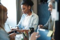 Office life. Diverse group of young businesspeople having a meeting together around a table in a modern office Royalty Free Stock Photo