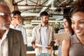 Office life. Modern business people discussing something and smiling while walking through the office corridor Royalty Free Stock Photo