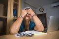 Office lifestyle portrait of sad and depressed middle aged attractive Asian woman working on laptop computer desk stressed and