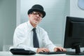 Office man types, bowler-wearer judges curiously