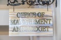 Office Of Management And Budget sign hanging on decrative wrought iron hanger