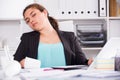 Office manager woman is sleeping at work after putting the reports