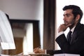 Office Manager Working On Computer At His Desk