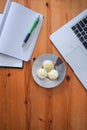 Office mock up with a laptop, notebook and pen with a plate of three rice cake muffins Royalty Free Stock Photo