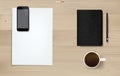 Office object background on wood. Working space area. Business background of white paper sheet, smartphone, coffee cup, notebook