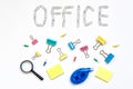 Office object. The word office, faded on a white background with metal stationery clips. The concept of office work Royalty Free Stock Photo