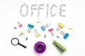 Office object. The word office, faded on a white background with metal stationery clips. The concept of office work Royalty Free Stock Photo