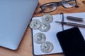 Office Portable work area Silver coins Bitcoin laptop Mobile phone Glasses, notebook and writing pen. Concept of Bitcoin Cryptocur