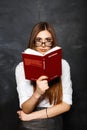 Office Pretty woman reading a book in the studio on a dark background. Royalty Free Stock Photo